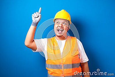 Asian workers wearing helmets are seen looking for ideas Stock Photo