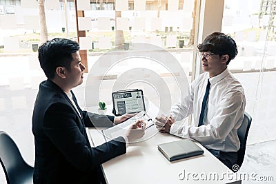 Asian young adult sitting at desk across from manager being interviewed job interview in business room Stock Photo