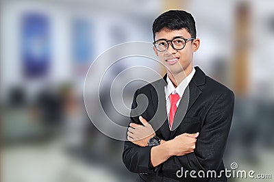 Asian young businessman standing with crossed arms. Casual business man with arms crossed. Happy businessman Stock Photo