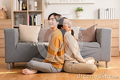 Asian young couple smile and laughing with positive emotion and loving together at warmth place. Attractive man and woman spending Stock Photo