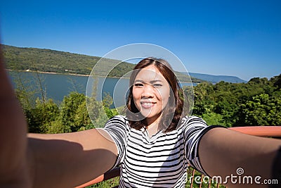 Asian young female tourist makes selfie Stock Photo