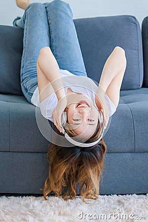 Asian young happy female wearing stereo wireless headset Stock Photo