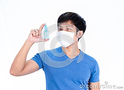 Asian young man in blue t-shirt top with medical mask and hand cleanser gel to protect COVID-19 with isolated on white background Stock Photo