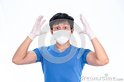 Asian young man in blue t-shirt top with medical mask and latex gloves to protect COVID-19 with isolated on white background Stock Photo