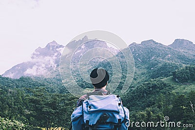 Asian young man in Scottish shirt and black hat hiking at mountain peak above clouds and fog Hiker outdoor. Doi Luang Chiang Dao C Editorial Stock Photo