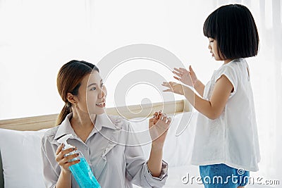 Asian Young mother washes her little girl`s hand by using a hand wash sanitizer gel. In the epidemic virus situation Stock Photo