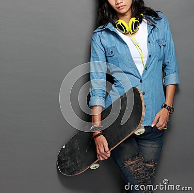 Asian young skater girl holding a skateboard Stock Photo