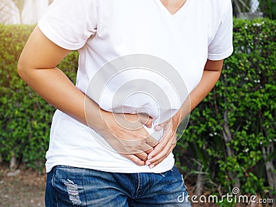Asian thai women suffering with severe stomach pain, Stomach ache or menstrual pain Stock Photo