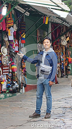 Asian young tourist at Mount Monserrate craft market in the city of Bogota Editorial Stock Photo