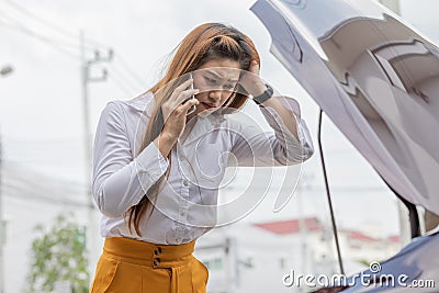 Asian young woman calling car insurance told problem and accident with her car broken on the road Stock Photo