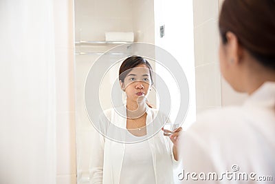 Asian young woman gargle on her mouth after tooth brushing Stock Photo