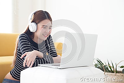 Asian young woman satisfied with learning language of online courses with laptop, Stock Photo