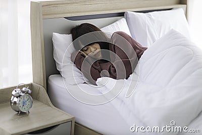 Asian young woman is sick and sleep in the bedroom. A girl hangover from a party last night and she is having a nightmare Stock Photo