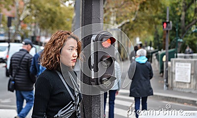 Asian young woman on street in Paris Editorial Stock Photo