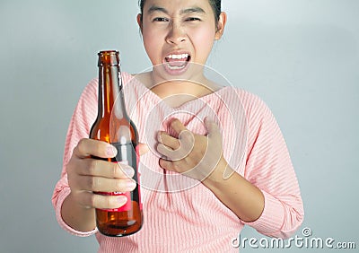 Asian young woman suffering from chest pain caused by heart disease from drink many alcohol. Dangerous lifestyle warning concept Stock Photo