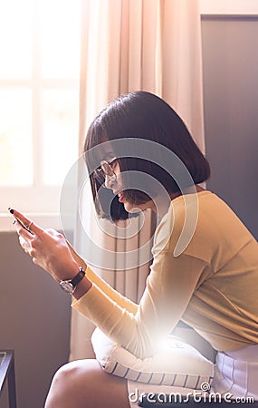 Asian young woman using smartphone at home,Searching or social networks,beautiful teenager Stock Photo