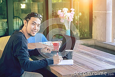 Asian younger freelance man working at home office with compute Stock Photo