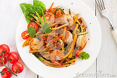 Asian zucchini noodle stir-fry with shrimps Stock Photo