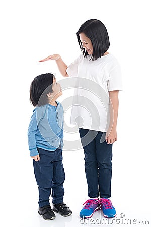 Asiangirl measures the growth of her brother Stock Photo