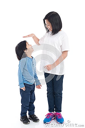 Asiangirl measures the growth of her brother Stock Photo