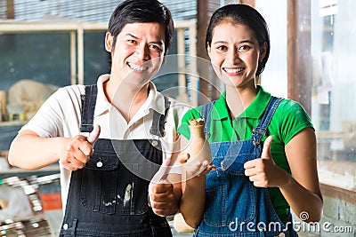 Asians with handmade pottery Stock Photo