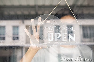 Asians with sign open and closed in restaurant for lockdown ideas unlock freedom tourist travel for lifestyle customer sign open Stock Photo