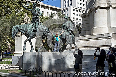 Asiatic tourist taking photos at Don Quixote statue Editorial Stock Photo