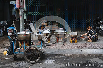 Asiatic woman prepare some street food on the road of saigon Editorial Stock Photo