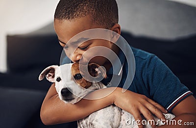 Asked for a brother, got a best friend instead. an adorable little boy playing with his pet dog on the bed at home. Stock Photo