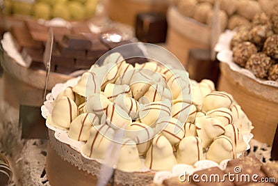 Asorted chocolate truffles and pralines. Chocolate and coconut candies on the counter in the confectionery store Stock Photo