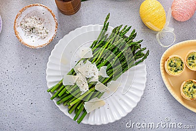 Asparagus cooked on a plate topped with parmesan Stock Photo