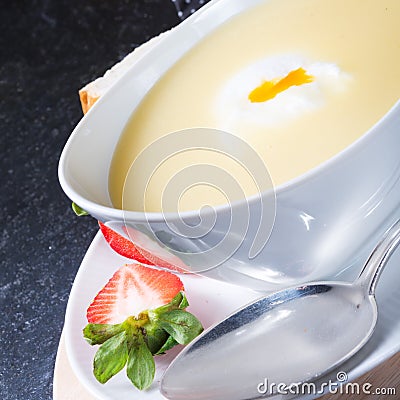 Asparagus soup with poached egg and fresh baguettes Stock Photo
