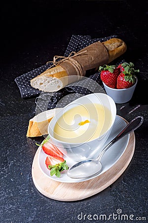 Asparagus soup with poached egg and fresh baguettes Stock Photo