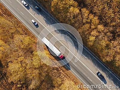 Asphalt highway or motorway road in countryside with car and truck traffic Cargo Semi Trailer Moving. Aerial Top View Stock Photo