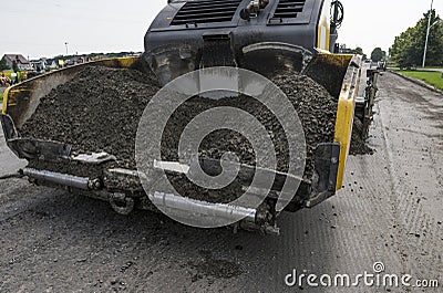 Asphalt paver machine during road construction and repairing works. A paver finisher, asphalt finisher or paving machine Stock Photo
