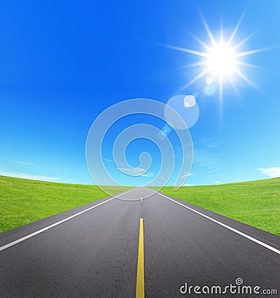 Asphalt road with cloudy sky and sunlight Stock Photo