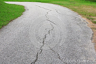 Asphalt road cracked. street in public park Stock Photo