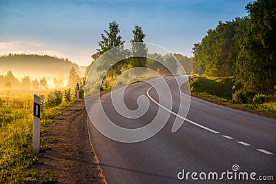 Road curve at sunrise Stock Photo