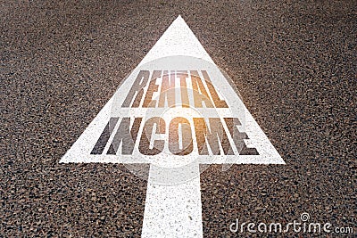 On the asphalt road markings an arrow with the inscription - RENTAL INCOME Stock Photo