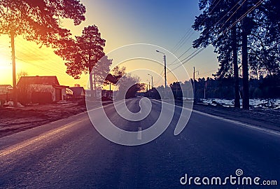 Asphalt road at sunrise and sunlight. Spring background Stock Photo