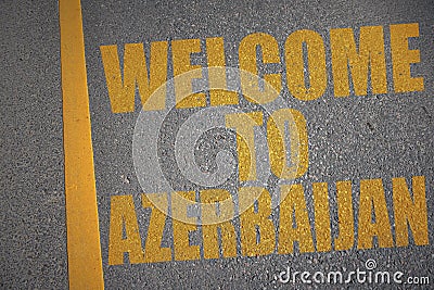 asphalt road with text welcome to azerbaijan near yellow line. Stock Photo