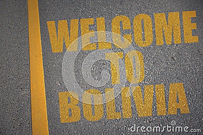 asphalt road with text welcome to bolivia near yellow line. Stock Photo