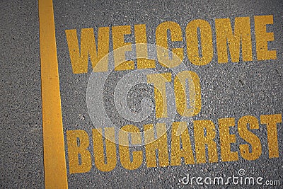 asphalt road with text welcome to Bucharest near yellow line Stock Photo