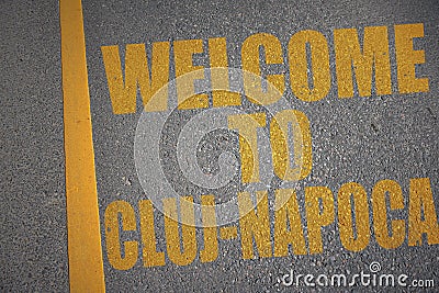 asphalt road with text welcome to Cluj-Napoca near yellow line Stock Photo