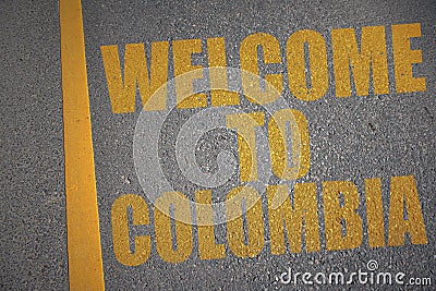 asphalt road with text welcome to colombia near yellow line. Stock Photo