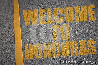 asphalt road with text welcome to honduras near yellow line. Stock Photo