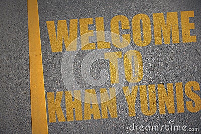 asphalt road with text welcome to Khan Yunis near yellow line Stock Photo