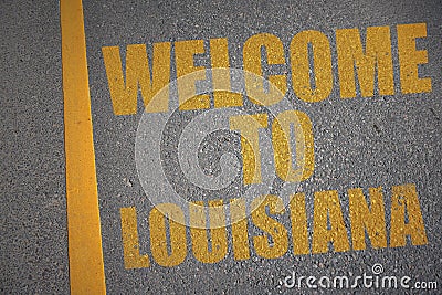 asphalt road with text welcome to louisiana near yellow line. Stock Photo