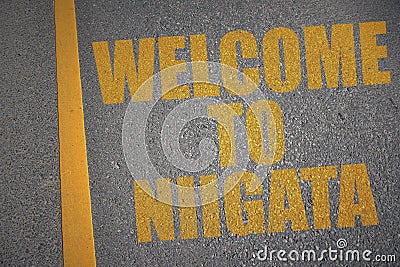 asphalt road with text welcome to Niigata near yellow line Stock Photo