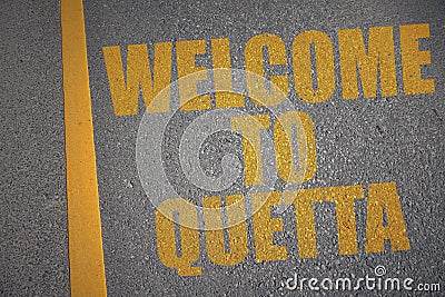 asphalt road with text welcome to Quetta near yellow line Stock Photo